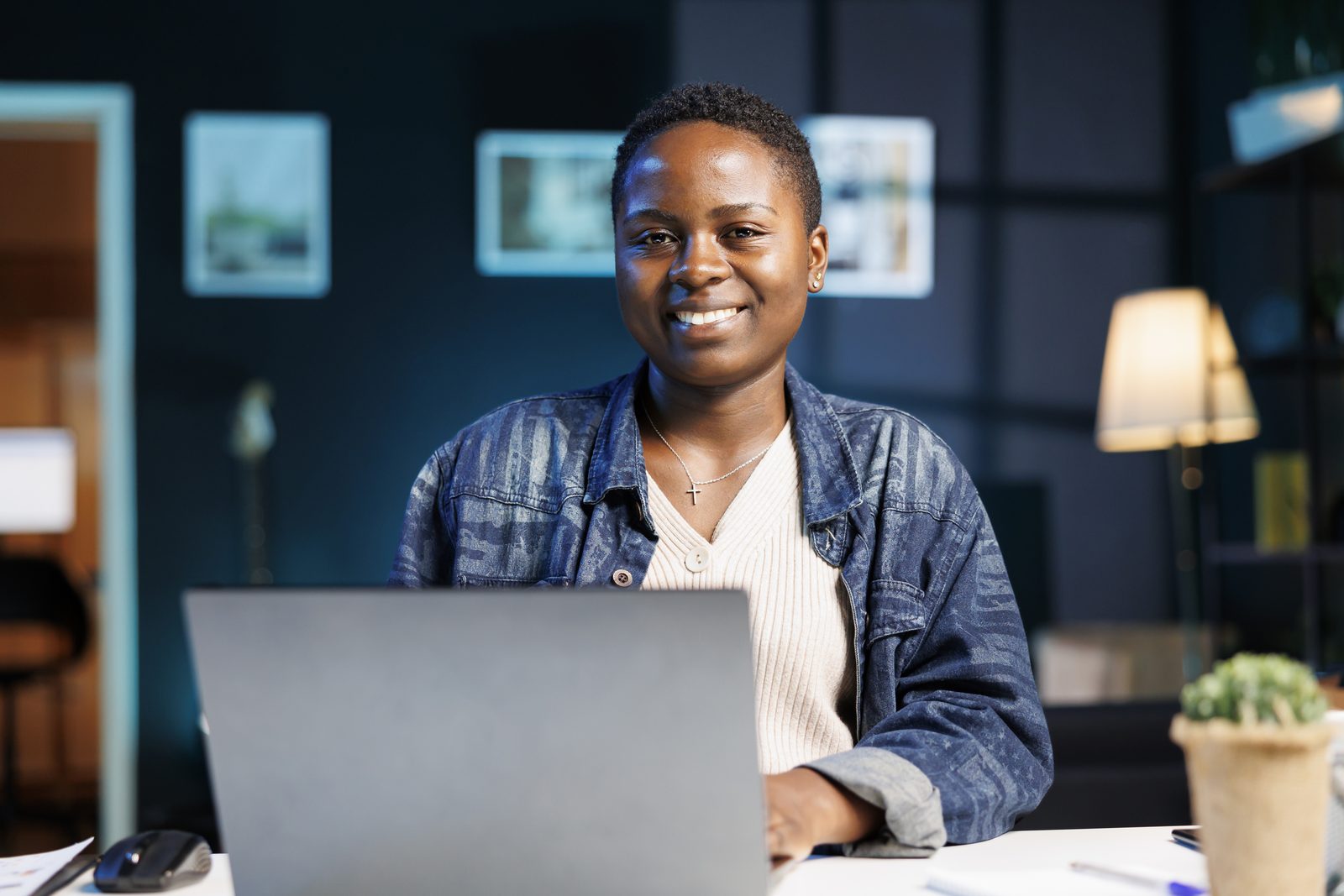 A guest smiling while working on a laptop